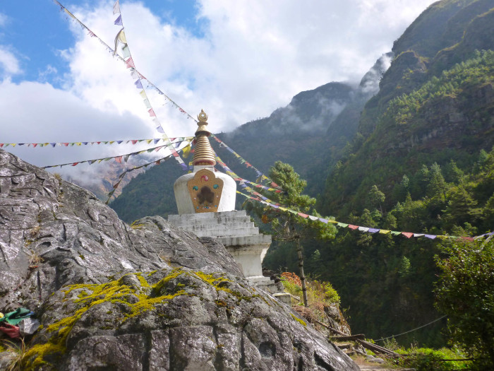 A chorten festooned with prayer flags