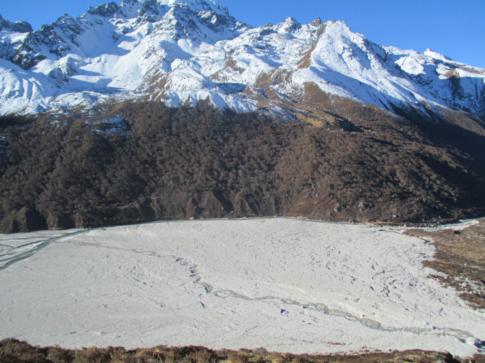 The white, rectangular flood plain at the foot of Tserko Ri.