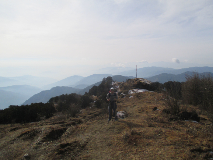 Rising above the smaller foothills.