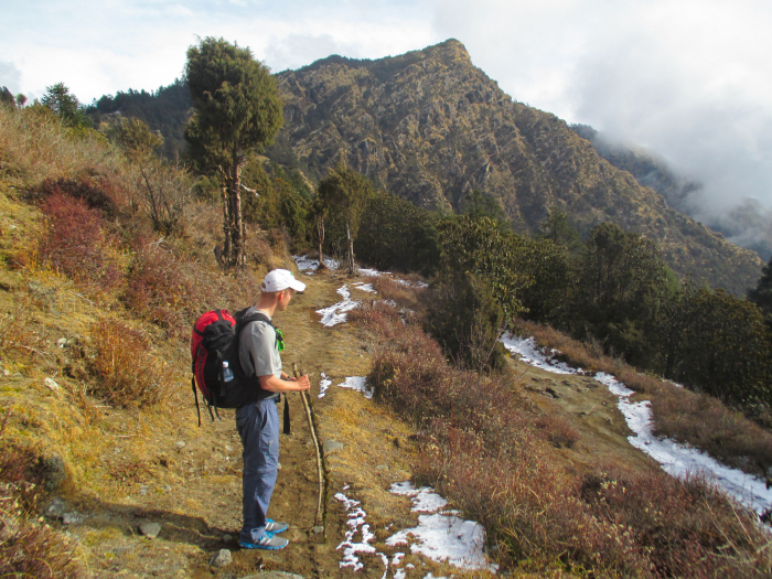Mike pondering below a craggy mountain.